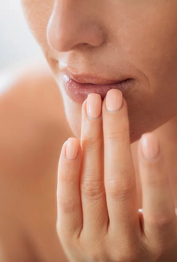 Photo of a woman touching her thin lips